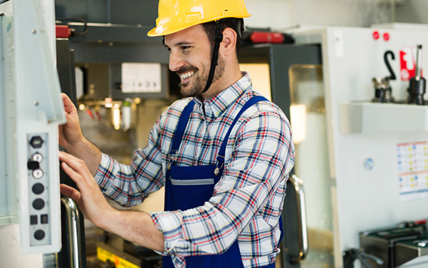 Man wearing hard hat and overalls.